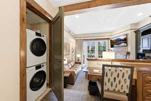 Laundry area with stacked washer / drying machine and recessed lighting