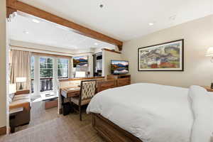 Bedroom featuring recessed lighting, access to exterior, beam ceiling, and dark colored carpet