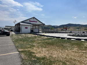 View of building exterior with a mountain view and uncovered parking