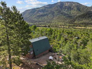 View of mountain backdrop featuring a heavily wooded area