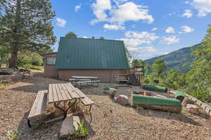 View of outdoor structure featuring an outdoor fire pit and a mountain view