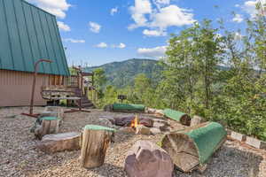 View of yard featuring a mountain view and an outdoor fire pit