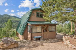 View of outdoor structure featuring a mountain view and a sunroom