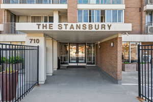 Entrance to property featuring  brick siding
