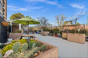 View of patio with grill and tables