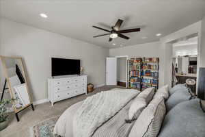 Bedroom featuring carpet floors, a ceiling fan, recessed lighting, and connected bathroom