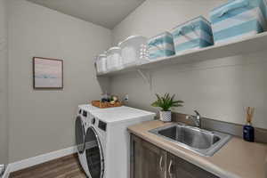 Laundry area featuring washing machine and clothes dryer and dark wood-style flooring