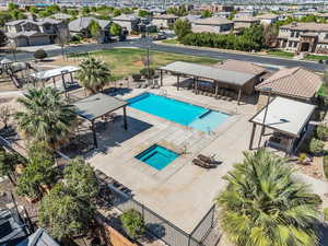 Community pool with a patio and a residential view