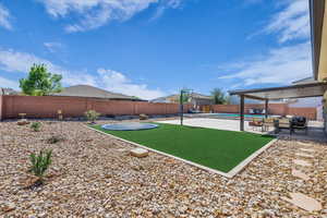 Fenced backyard featuring a patio and an outdoor hangout area