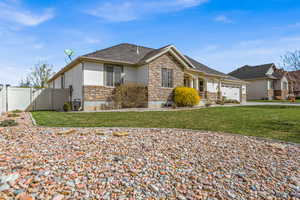 View of front of home featuring stone siding, stucco siding, a garage, driveway, and a shingled roof
