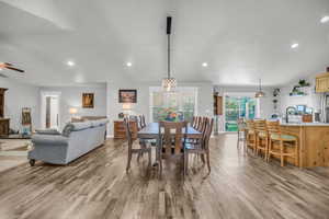 Dining space featuring recessed lighting, light wood-style flooring, a ceiling fan, and vaulted ceiling