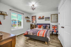 Bedroom with light wood-style flooring and a closet