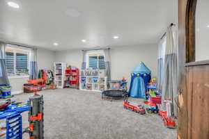 Recreation room with carpet flooring, healthy amount of natural light, and recessed lighting