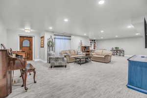 Living room with light colored carpet and recessed lighting