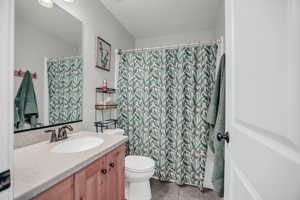 Bathroom with vanity, a shower with curtain, and light tile patterned floors