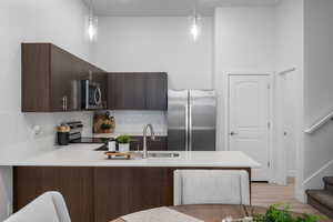 Kitchen with dark wood tone finishes and stainless steel appliances. *fridge not included*