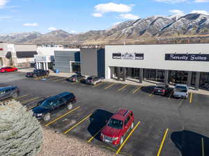 View of commercial location with uncovered parking and a mountain view