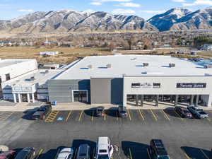 View of commercial property with a mountain view and uncovered parking