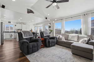 Living room with dark wood-style flooring, ceiling fan, and recessed lighting