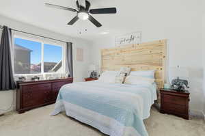Bedroom featuring light carpet and a ceiling fan