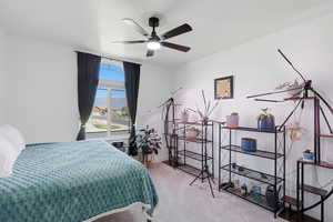 Bedroom with ceiling fan and light carpet