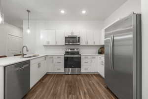 Bright white kitchen with stainless steel appliances. *fridge not included*