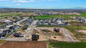 Aerial overview of property's location with nearby suburban area and a mountainous background