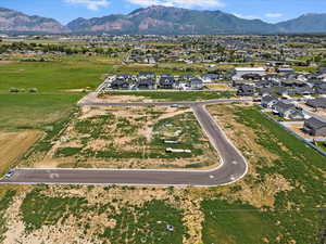 Aerial view of property's location with a mountainous background and nearby suburban area