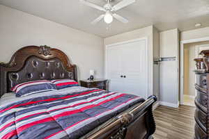 Bedroom featuring wood finished floors, ceiling fan, and a closet