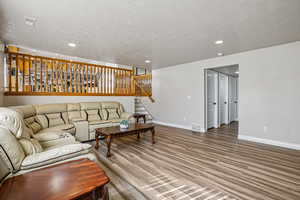 Living room featuring light wood finished floors and recessed lighting