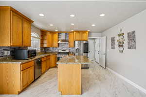 Kitchen featuring open shelves, dark stone counters, stainless steel appliances, a center island, and recessed lighting