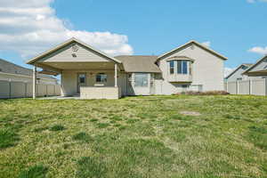 Back of house featuring a patio and roof with shingles