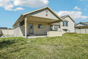 Rear view of property with a gate, a patio area, and entry steps