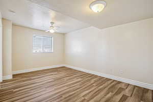 Empty room featuring light wood-style flooring and ceiling fan
