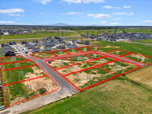 Aerial view of residential area featuring property parcel outlined and mountains