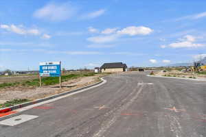 View of asphalt street featuring curbs