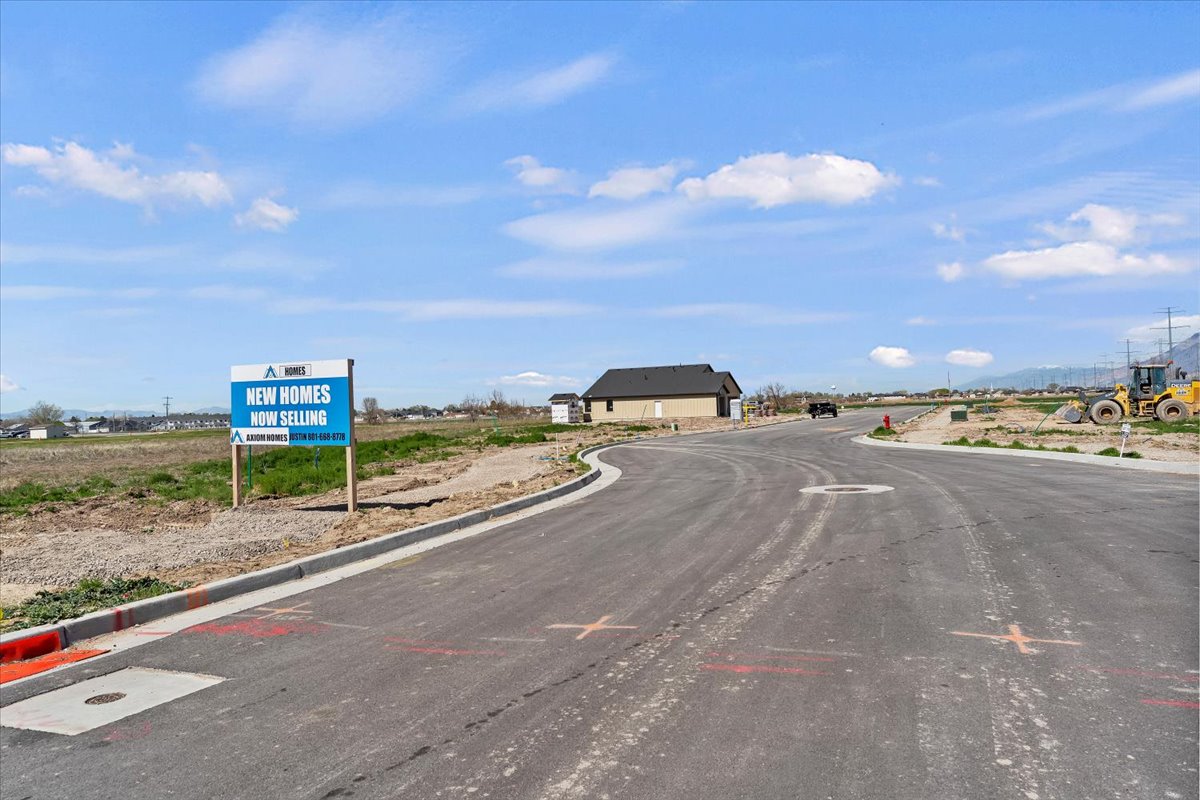 View of asphalt street featuring curbs
