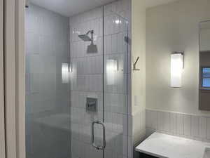 Full bathroom featuring a stall shower and vanity