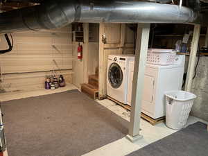 Unfinished basement featuring washing machine and dryer