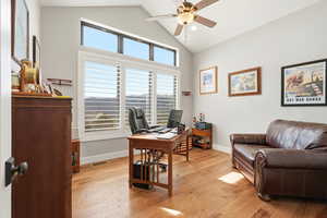 Home office featuring light wood-type flooring, vaulted ceiling, ceiling fan, and recessed lighting