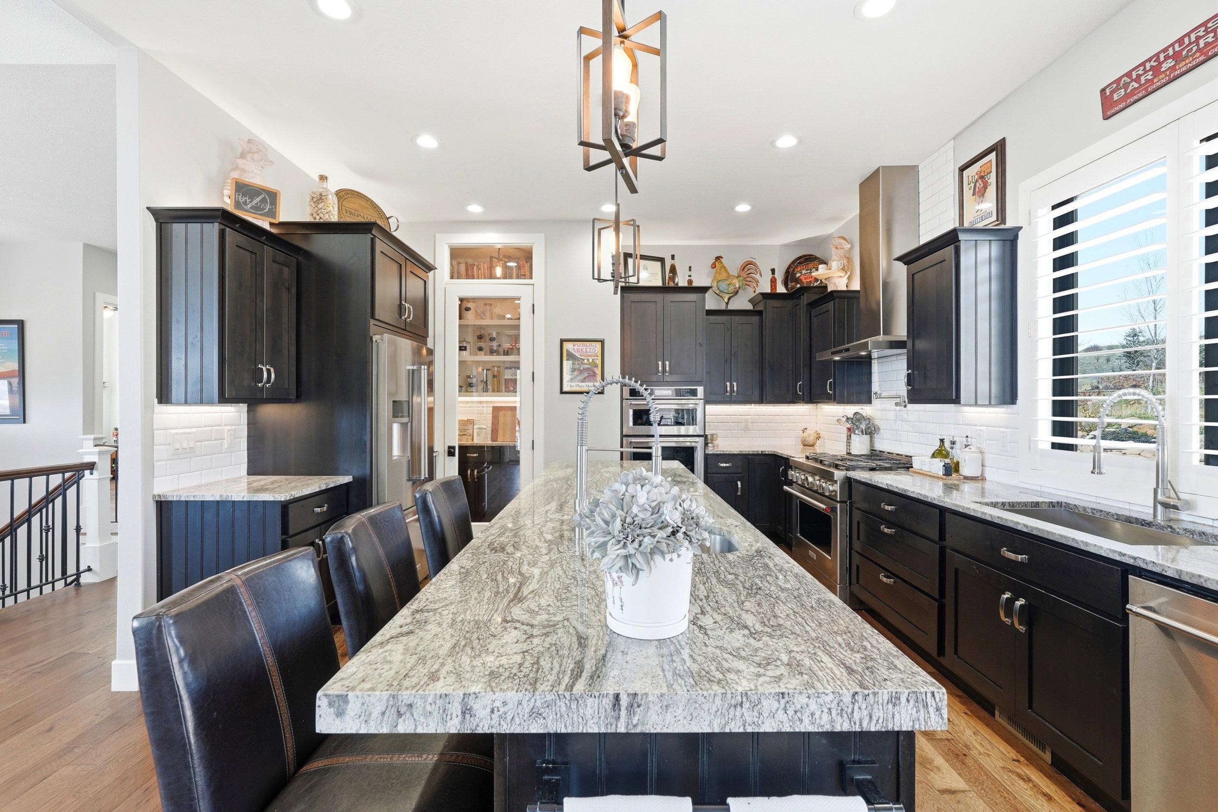 Kitchen with a kitchen bar, tasteful backsplash, light stone countertops, and premium appliances