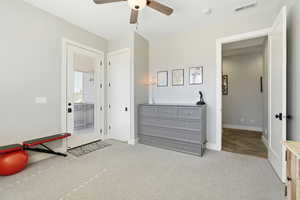 Bedroom featuring light colored carpet and a ceiling fan