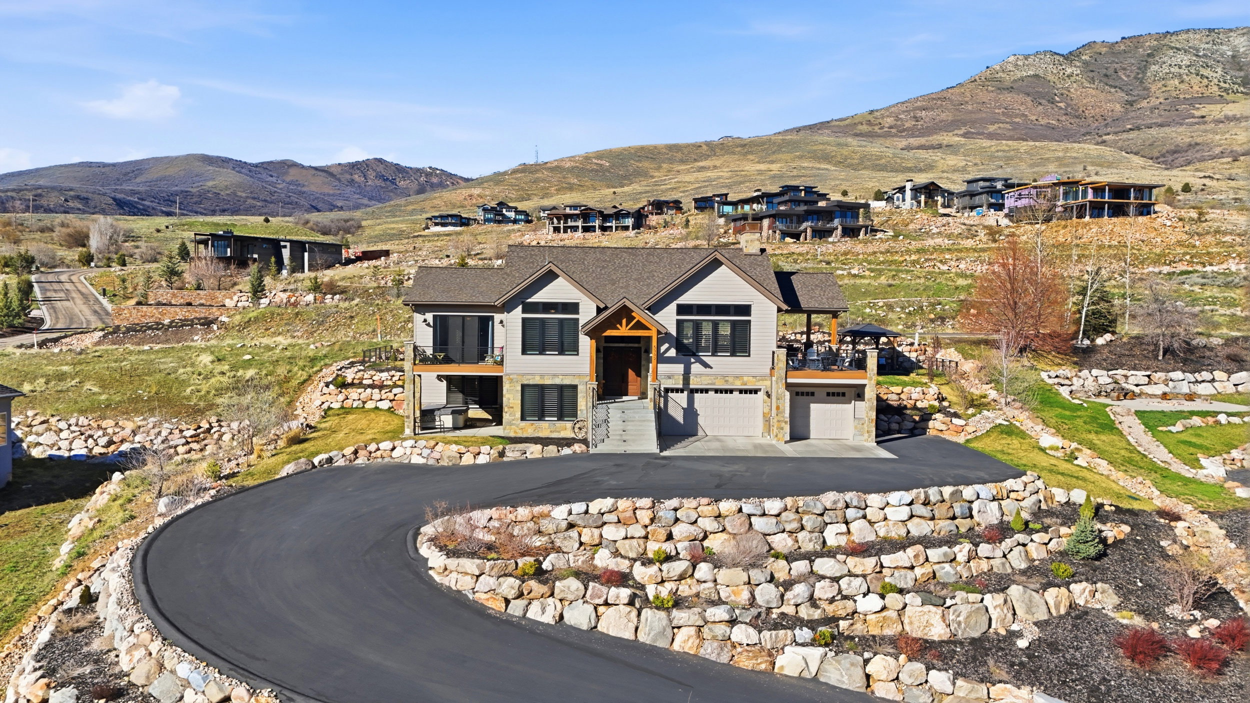 View of front facade with a mountain view, an attached garage, and asphalt driveway