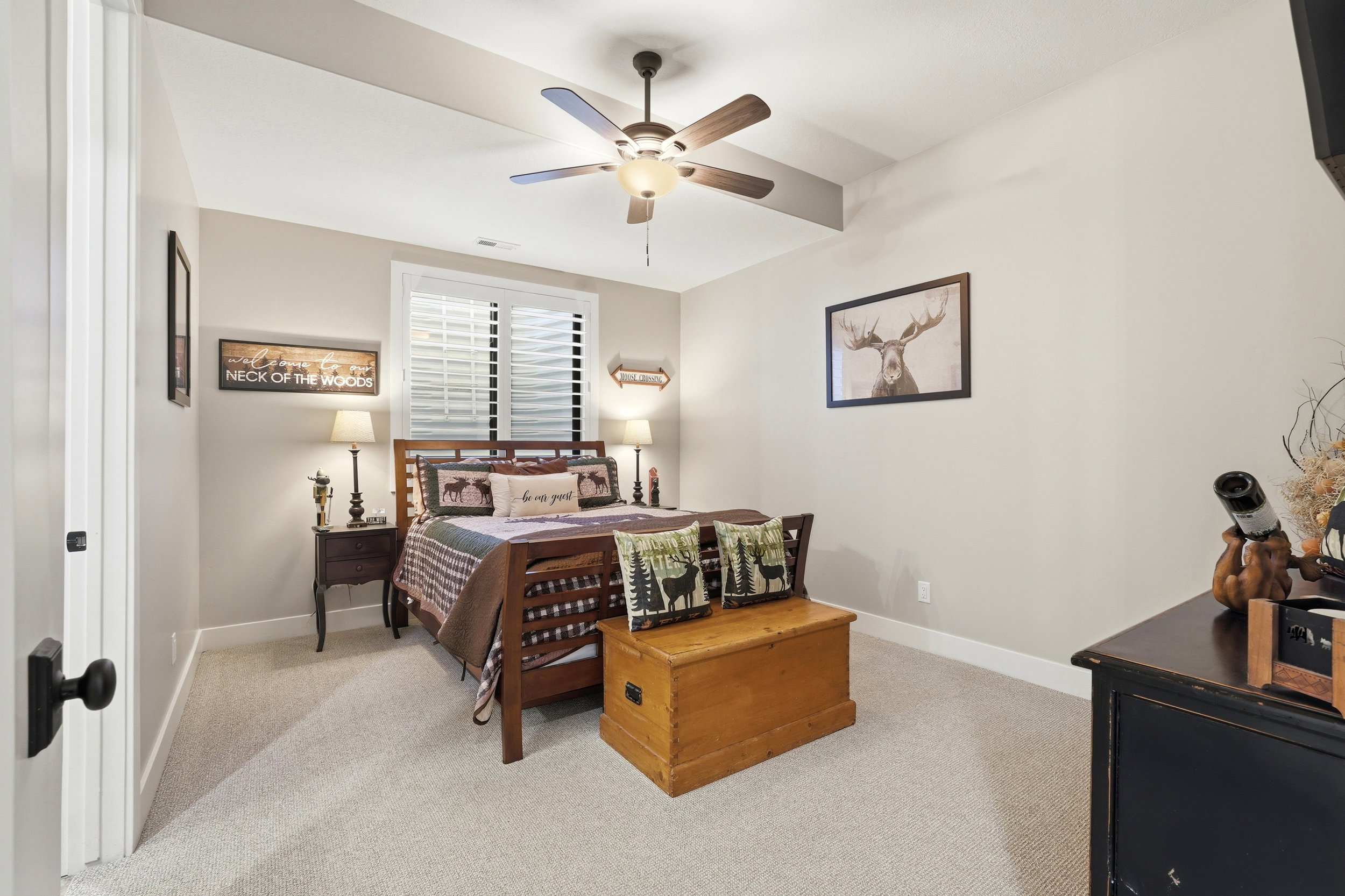 Bedroom with light colored carpet and a ceiling fan