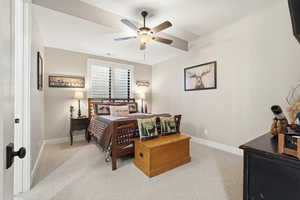 Bedroom with light colored carpet and a ceiling fan
