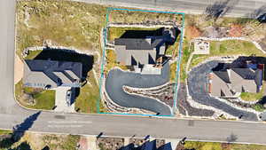 Aerial perspective of suburban area featuring property boundaries highlighted