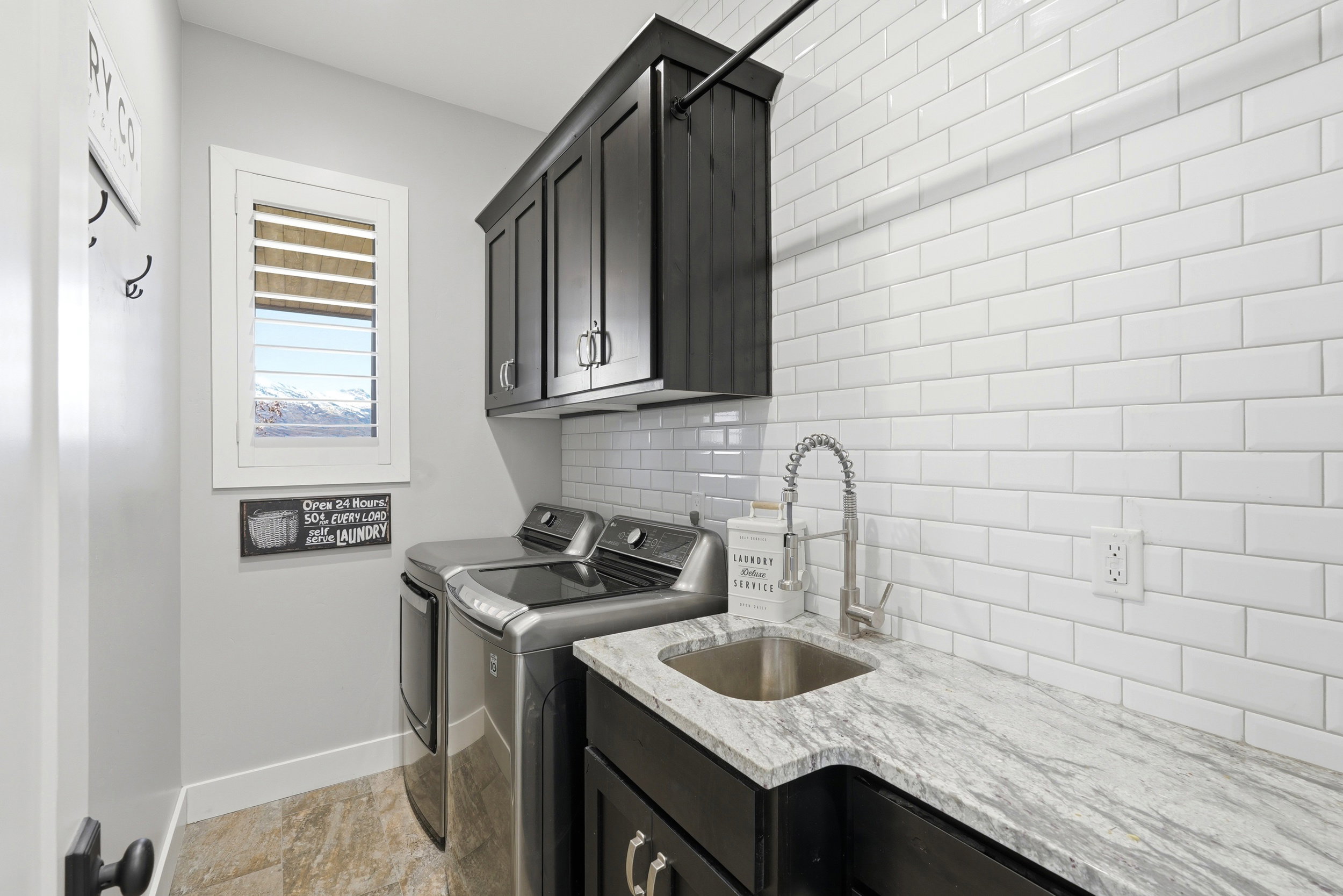 Laundry room featuring washing machine and clothes dryer and cabinet space