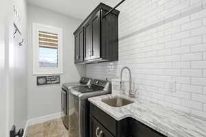 Laundry room featuring washing machine and clothes dryer and cabinet space