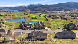 Aerial view of residential area with a water and mountain view and a golf club