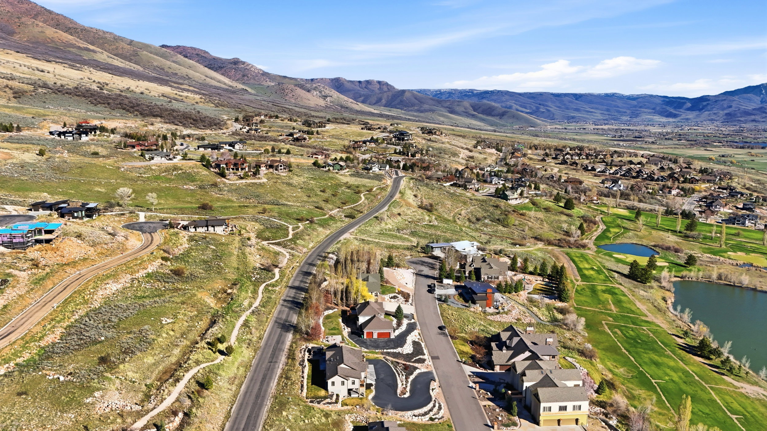 Aerial perspective of suburban area featuring a water and mountain view